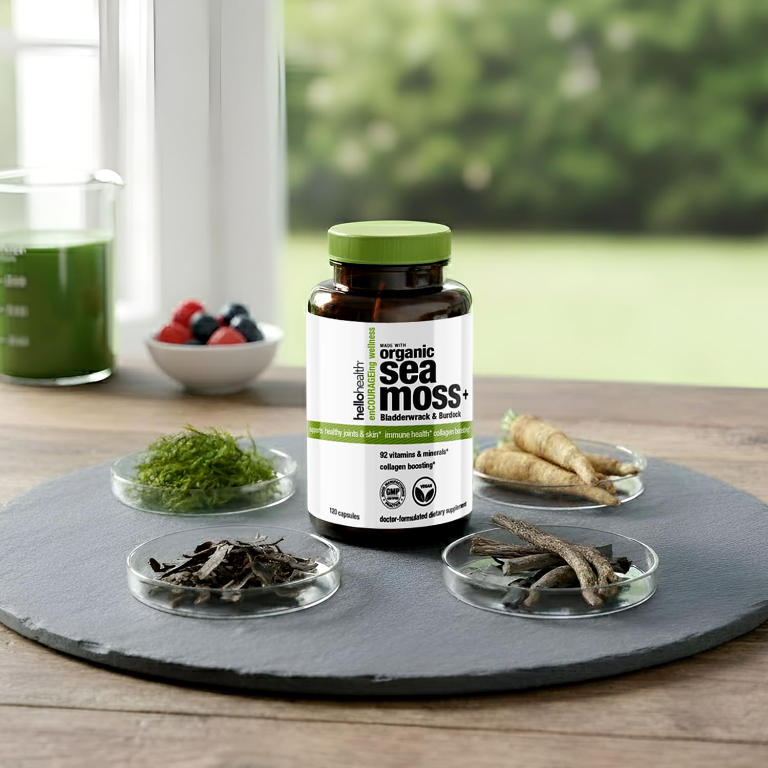 HELLO HEALTH Organic Sea Moss Capsules next to a glass of water