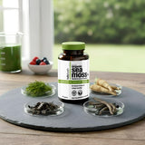 HELLO HEALTH Organic Sea Moss Capsules next to a glass of water