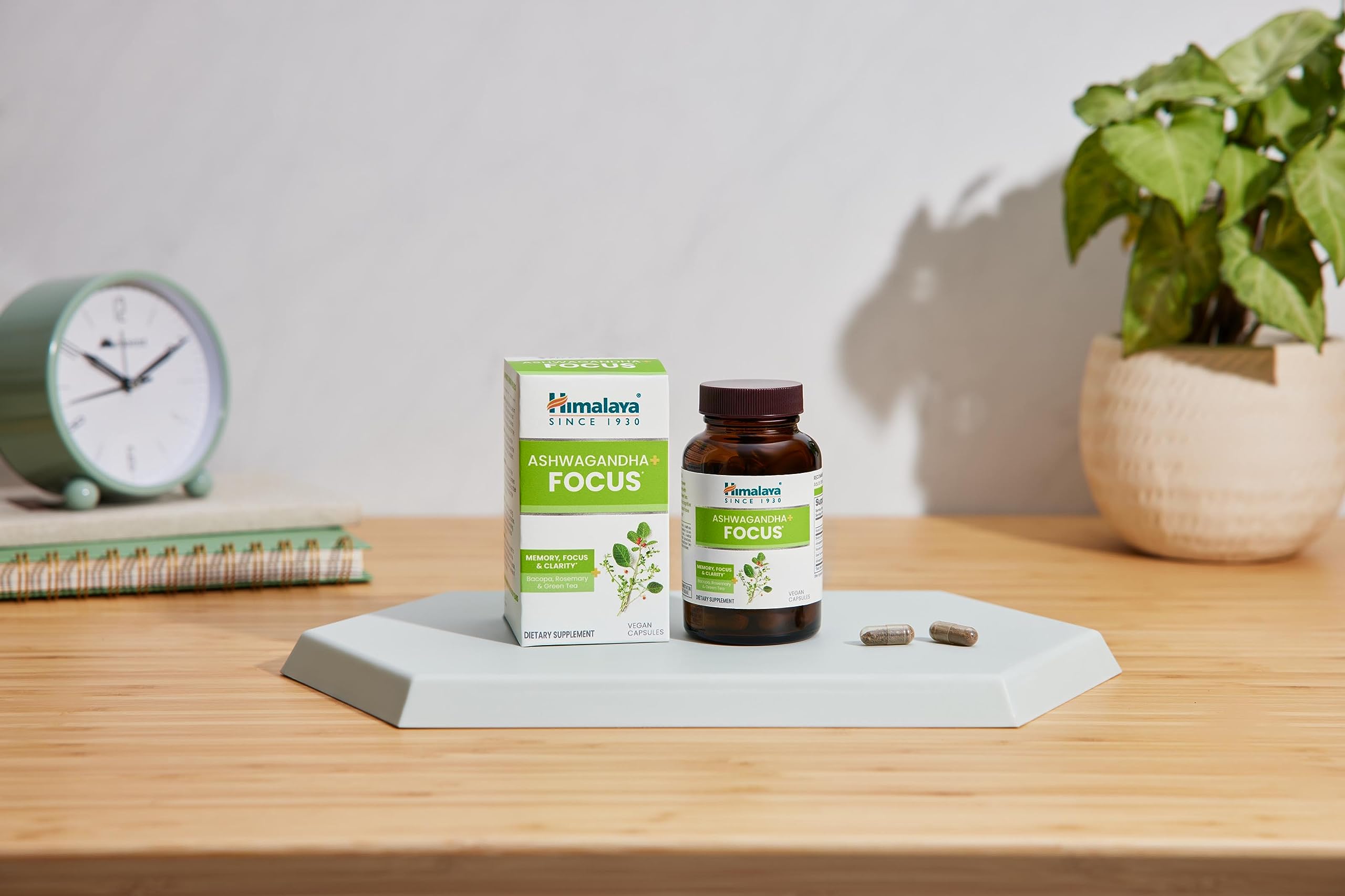 Himalaya Ashwagandha Capsules with a measuring spoon and glass of water