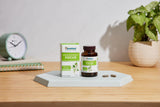 Himalaya Ashwagandha Capsules with a measuring spoon and glass of water