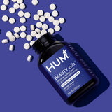HUM Beauty zzZz Sleep Supplement with a nightstand setting
