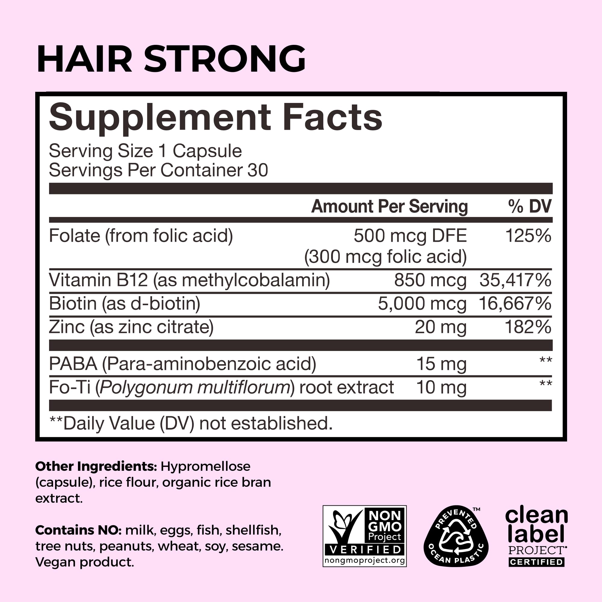 HUM Hair Supplement Capsules on a wooden table