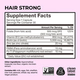 HUM Hair Supplement Capsules on a wooden table