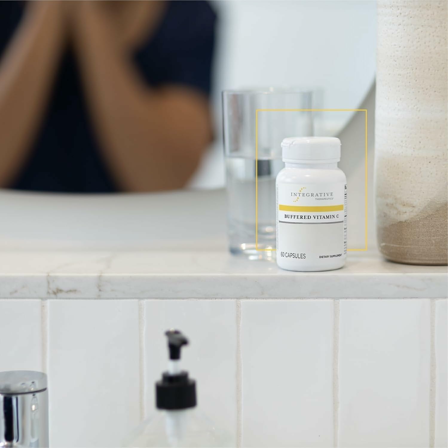 Integrative Therapeutics Buffered Vitamin C 1000mg capsules on a wooden table
