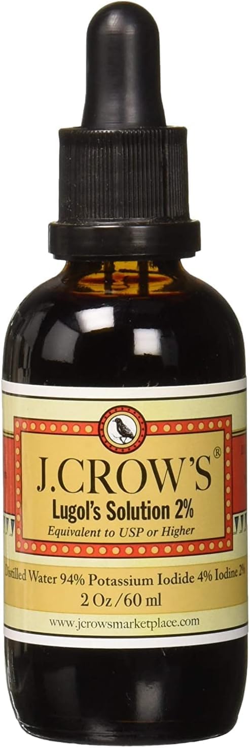 J. CROW'S Iodine Solution and book on a wooden table