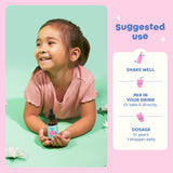 JoySpring Burst B12 kids vitamin B complex liquid supplement with a glass of juice