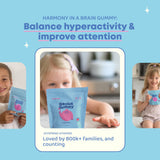 JoySpring Genius Laser Focus Gummies on a table with a child's school supplies