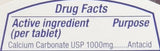 KIRKLAND Sleep Aid Tablets on a table with a glass of water