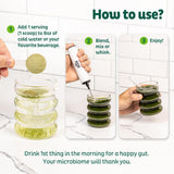 KOS Superfood Greens Powder in a glass of cold water