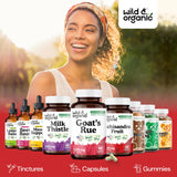 Lifestyle shot with Wild & Organic Goat's Rue Capsules and a glass of water