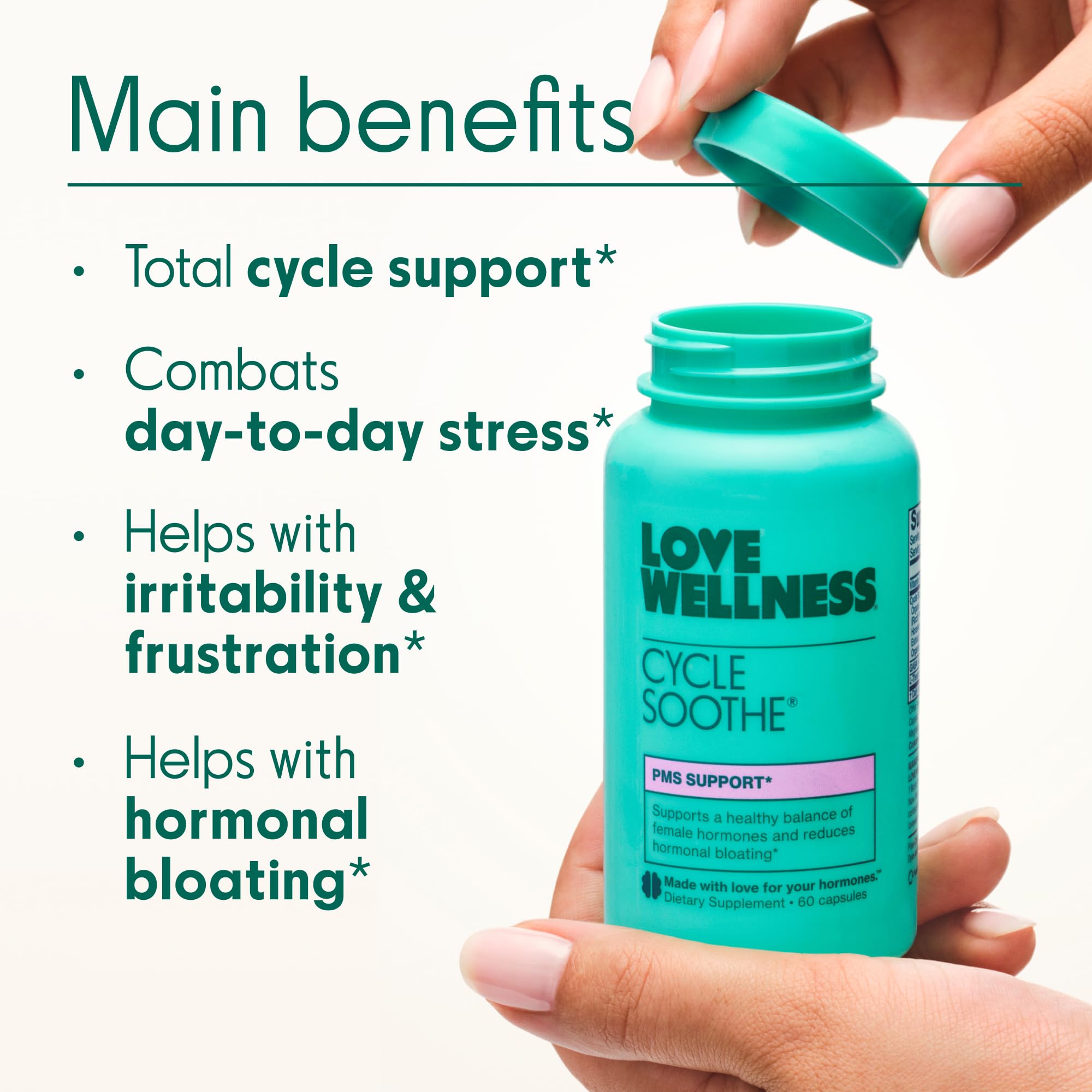Love Wellness Cycle Soothe capsules in a hand