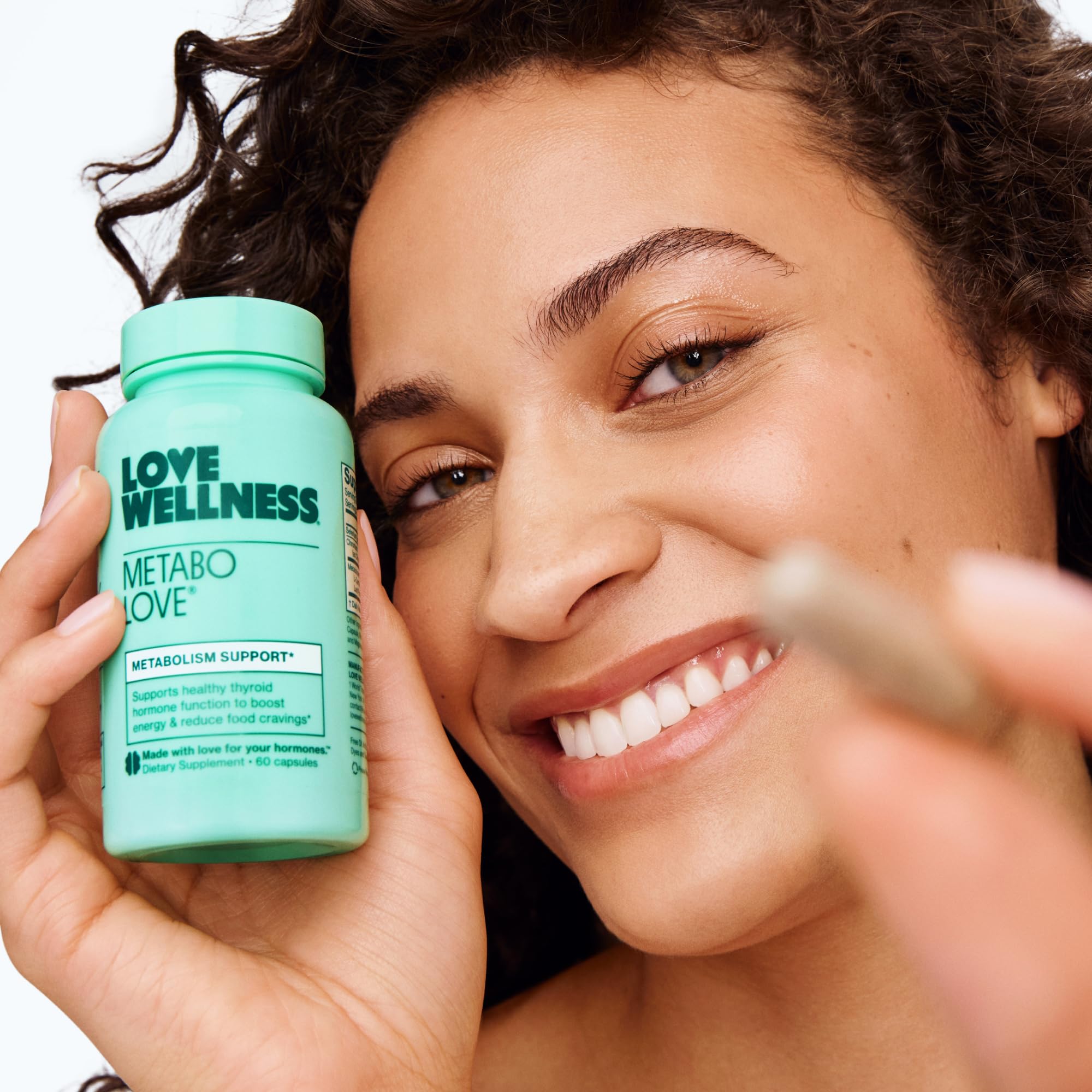 Love Wellness Daily Supplement with a measuring spoon for dosage