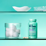 Love Wellness Hello Burn Balance capsules on a wooden table