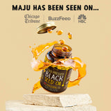 Maju Superfoods Black Seed Oil Capsules on a wooden table