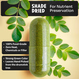 Maju Superfoods Moringa Capsules displayed on a wooden table
