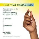 MegaFood Ashwagandha Stress Support Mini Tablets displayed with herbs