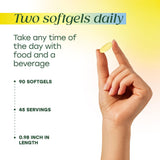 MegaFood Omega-3 Fish Oil Softgels alongside a glass of water