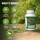 MERRY VITA Moringa Capsules bottle with capsules on wooden surface