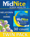 MidNite Natural Sleep Supplement tablets in a hand