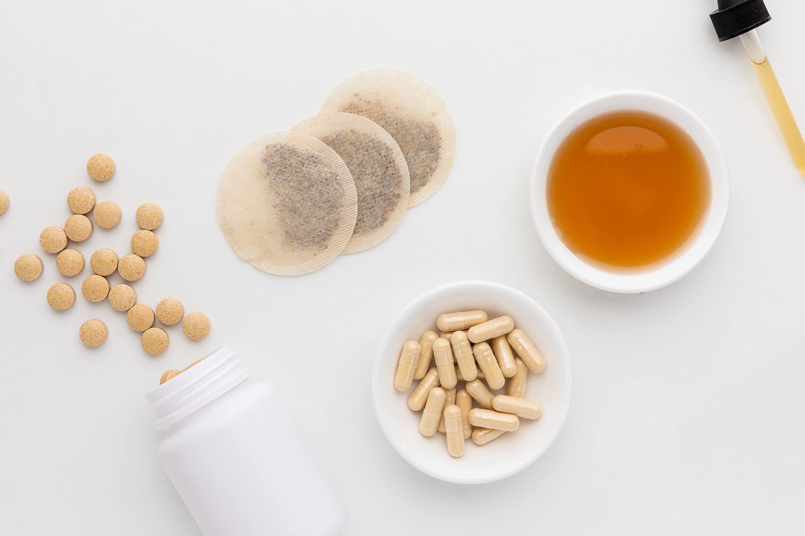 Milk Thistle Seed Powder with fresh herbs background