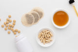 Milk Thistle Seed Powder with fresh herbs background