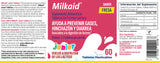 Milkaid Strawberry Tablets in a hand with a glass of water