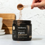 MINDHONEY Organic Colostrum Chocolate Powder in a smoothie