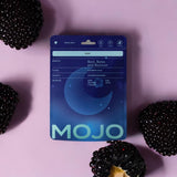 Mojo Sleep Gummies on a wooden surface with a calming background