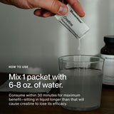 Momentous Creatine Powder 75g on a gym bench with weights