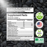 Mother Nature Organics Black Seed Oil softgels on a wooden surface