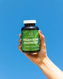 MRM Vegan Bone Maximizer capsules on a wooden surface