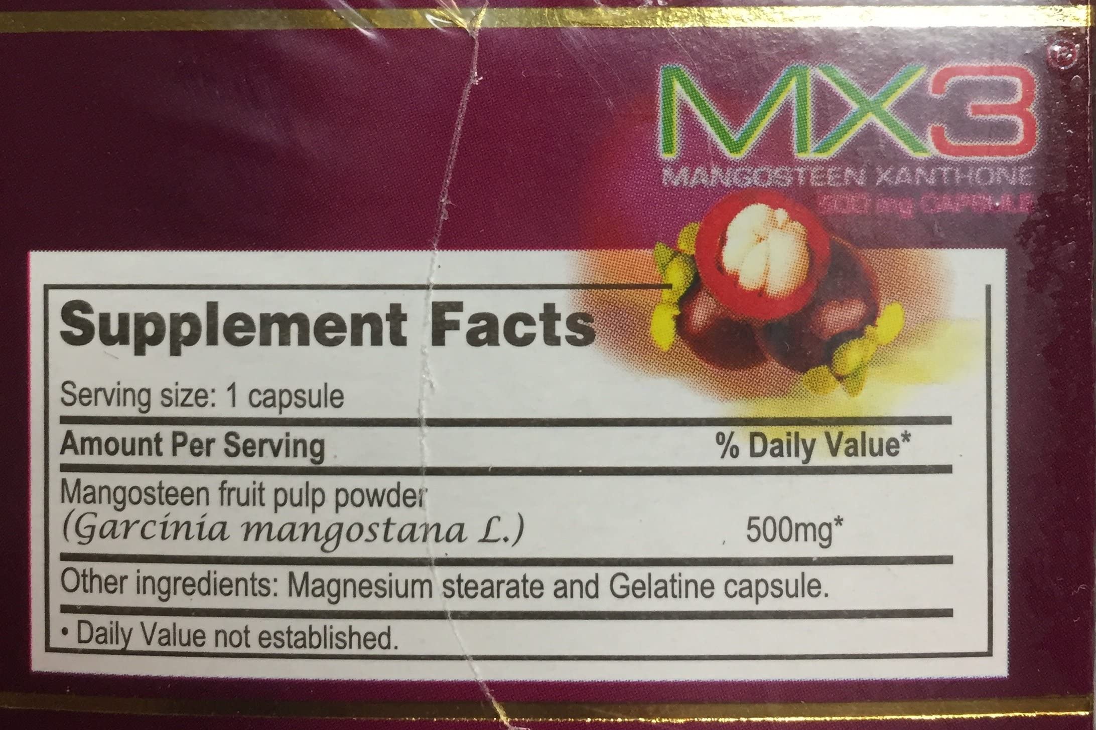 MX3 Mangosteen supplement capsules on a wooden surface