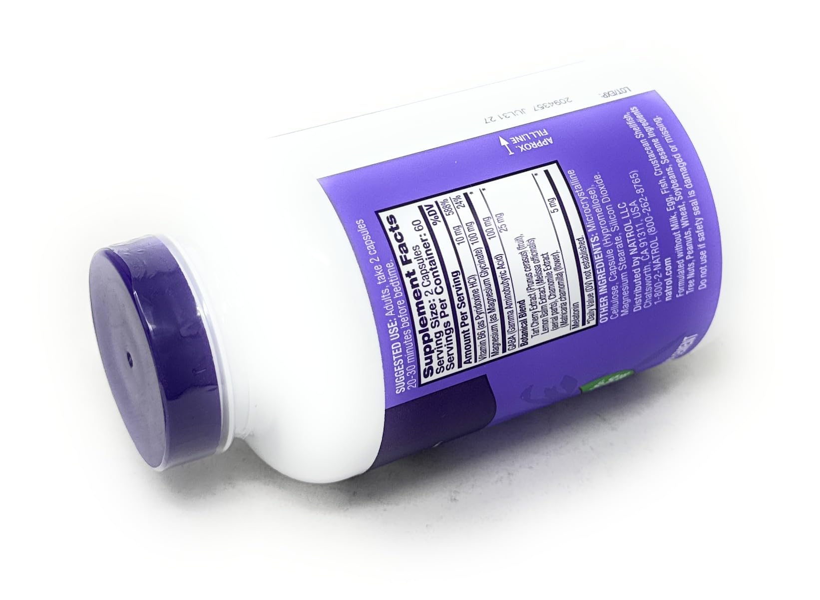 Natrol Sleep & Restore Capsules on a wooden table
