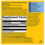 Nature Made Melatonin 3mg bottle with a glass of water