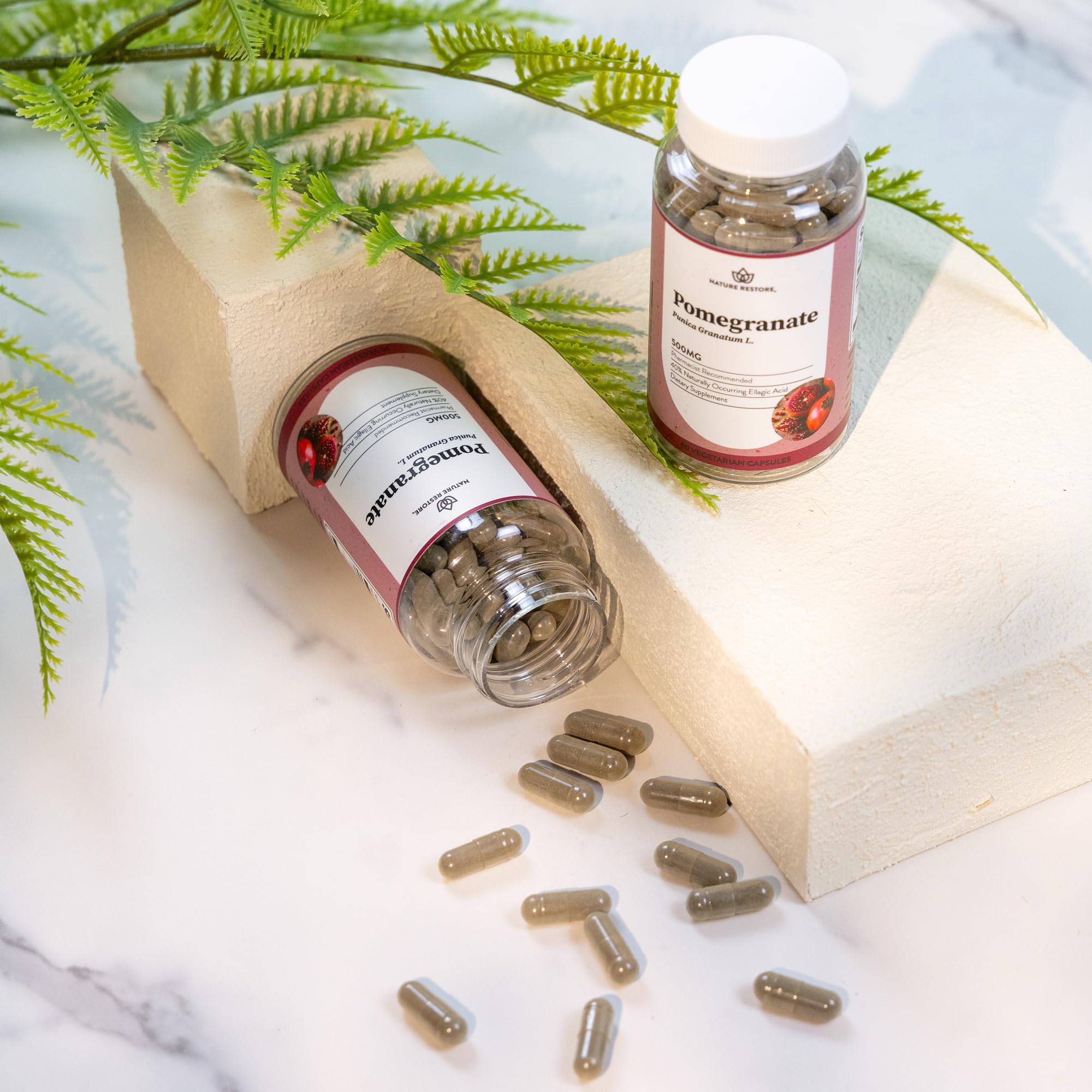 Nature Restore Pomegranate Extract Supplement in lifestyle setting on a wooden table
