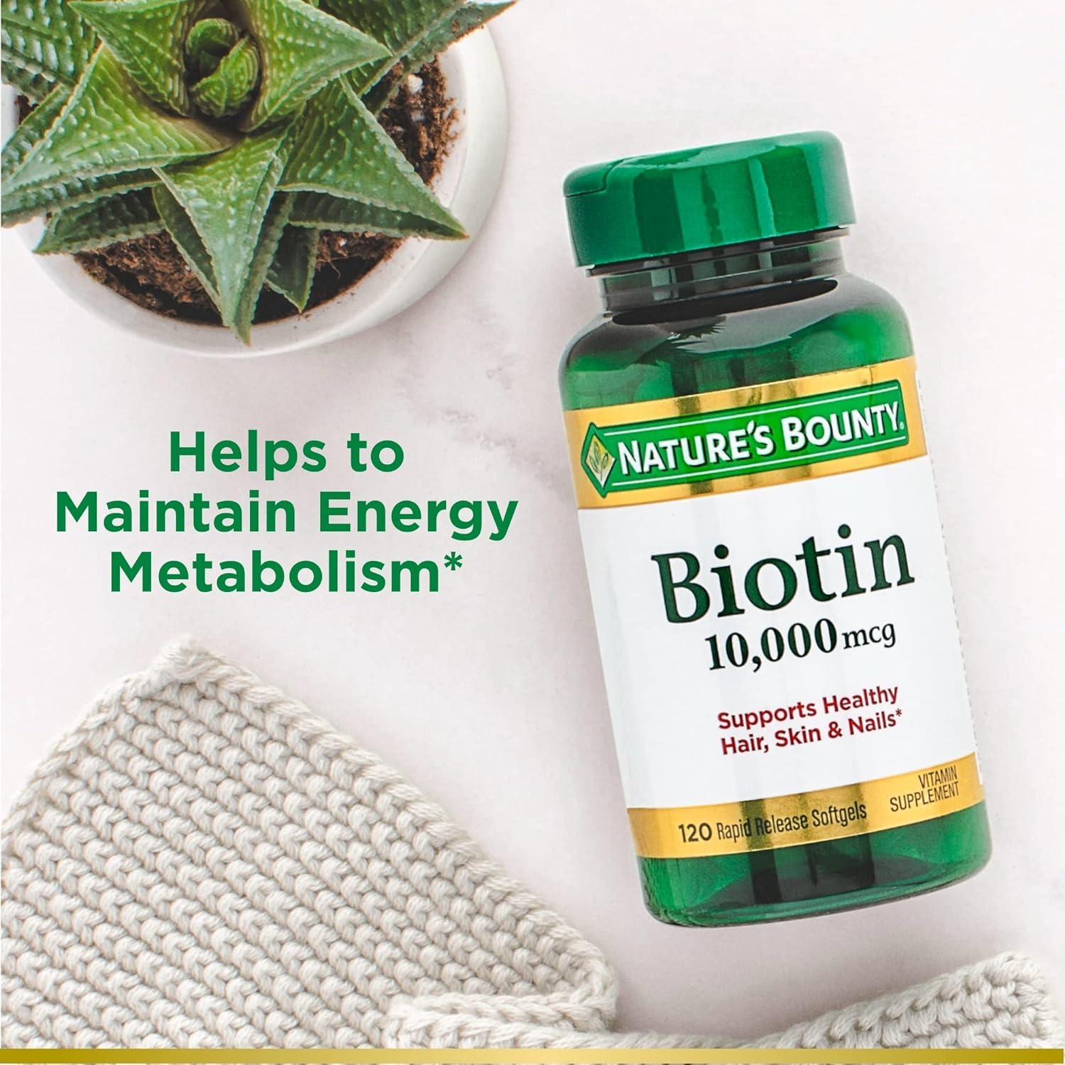 Nature's Bounty Biotin softgels on a wooden table