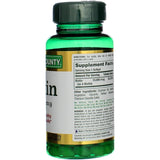 Nature's Bounty Biotin Supplement 68g on a wooden table