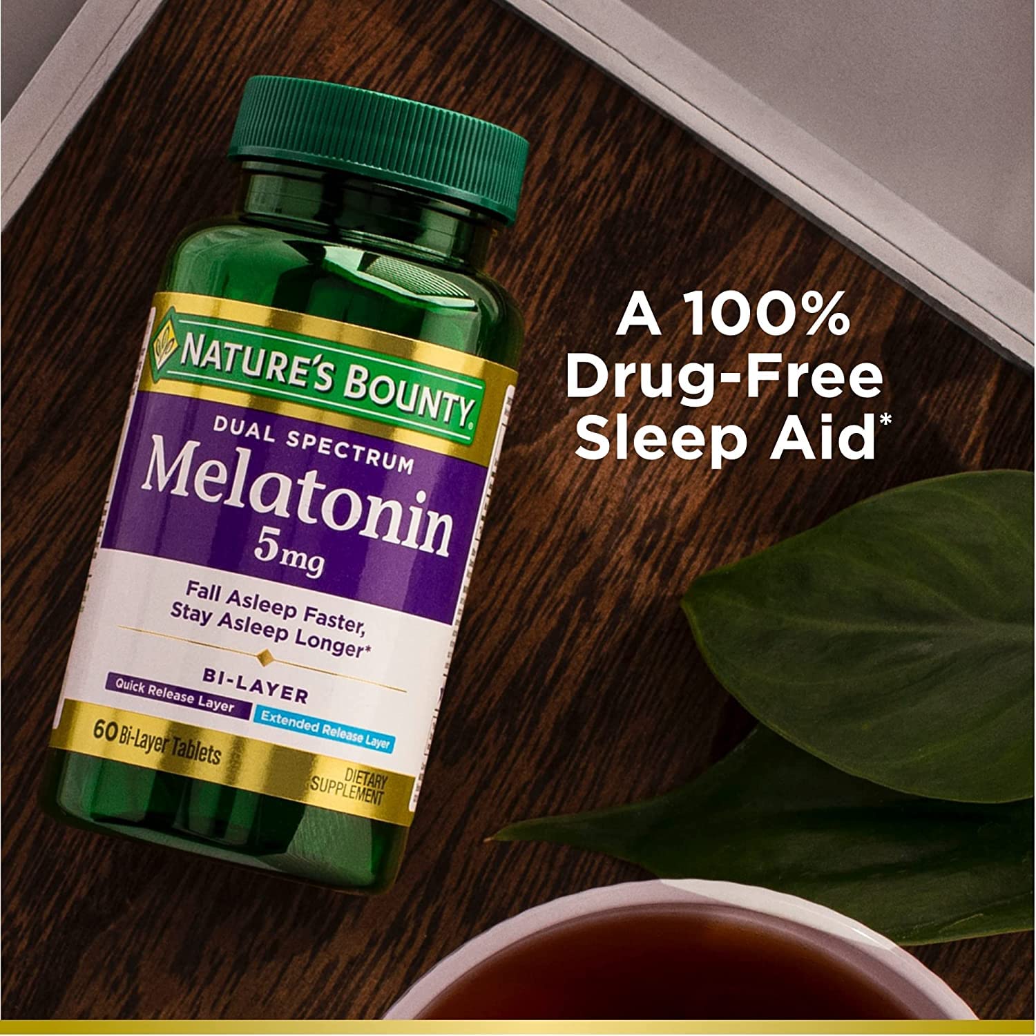 Nature's Bounty Dual Spectrum Melatonin tablets on a wooden surface