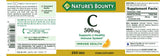 Nature's Bounty Vitamin C 500mg caplets on a wooden table