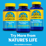 Nature's Life Cal Mag Zinc Complex capsules on a wooden surface