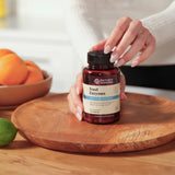 Nature's Sunshine Multi-Enzymes capsules on a wooden table