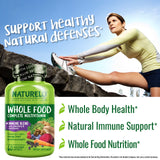 NATURELO Whole Food Multivitamin capsules on a wooden surface