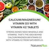NaturesPlus Cal/Mag/Vit D3 supplement capsules on a wooden table