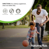 NaturesPlus Orange Juice Vitamin C Chewable Tablets on a wooden table