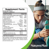 NaturesPlus Ultra Hair supplement packaging on a wooden table