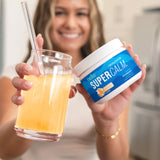 Nello Supercalm Adaptogenic Powder Drink Mix in a glass