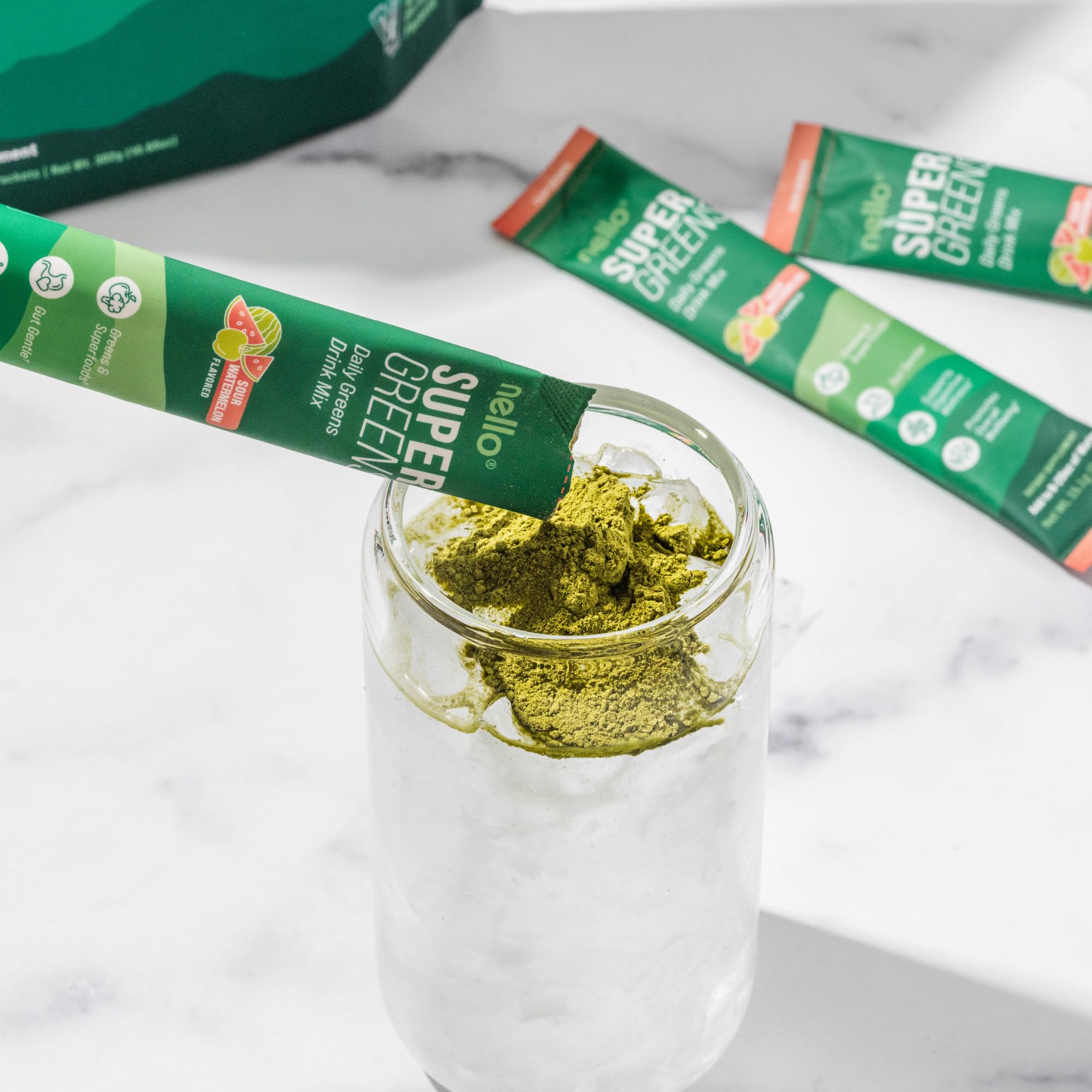Nello Supergreens Superfood Greens Drink Mix with spoonful of powder