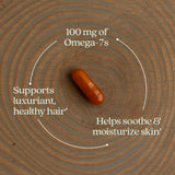 New Chapter Omega-7 Sea Buckthorn Blend capsule in hand