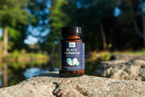 New Universe Food Black Turmeric Capsules 350MG capsules on a wooden surface