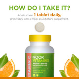 Noor Vitamins Vitamin C chewable tablets beside fresh oranges